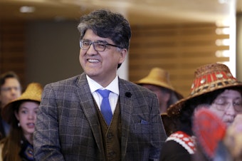 caption: Author and filmmaker Sherman Alexie waits with dancers backstage for his turn on stage as the keynote speaker at a celebration of Indigenous Peoples' Day Monday, Oct. 10, 2016, at Seattle's City Hall. 