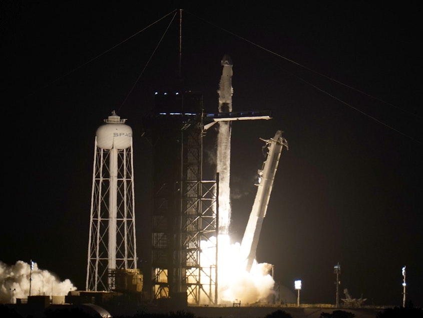 caption: A SpaceX Falcon 9 rocket with the Crew Dragon space capsule lifts off from Pad 39A at Kennedy Space Center in Cape Canaveral, Fla., on Friday.