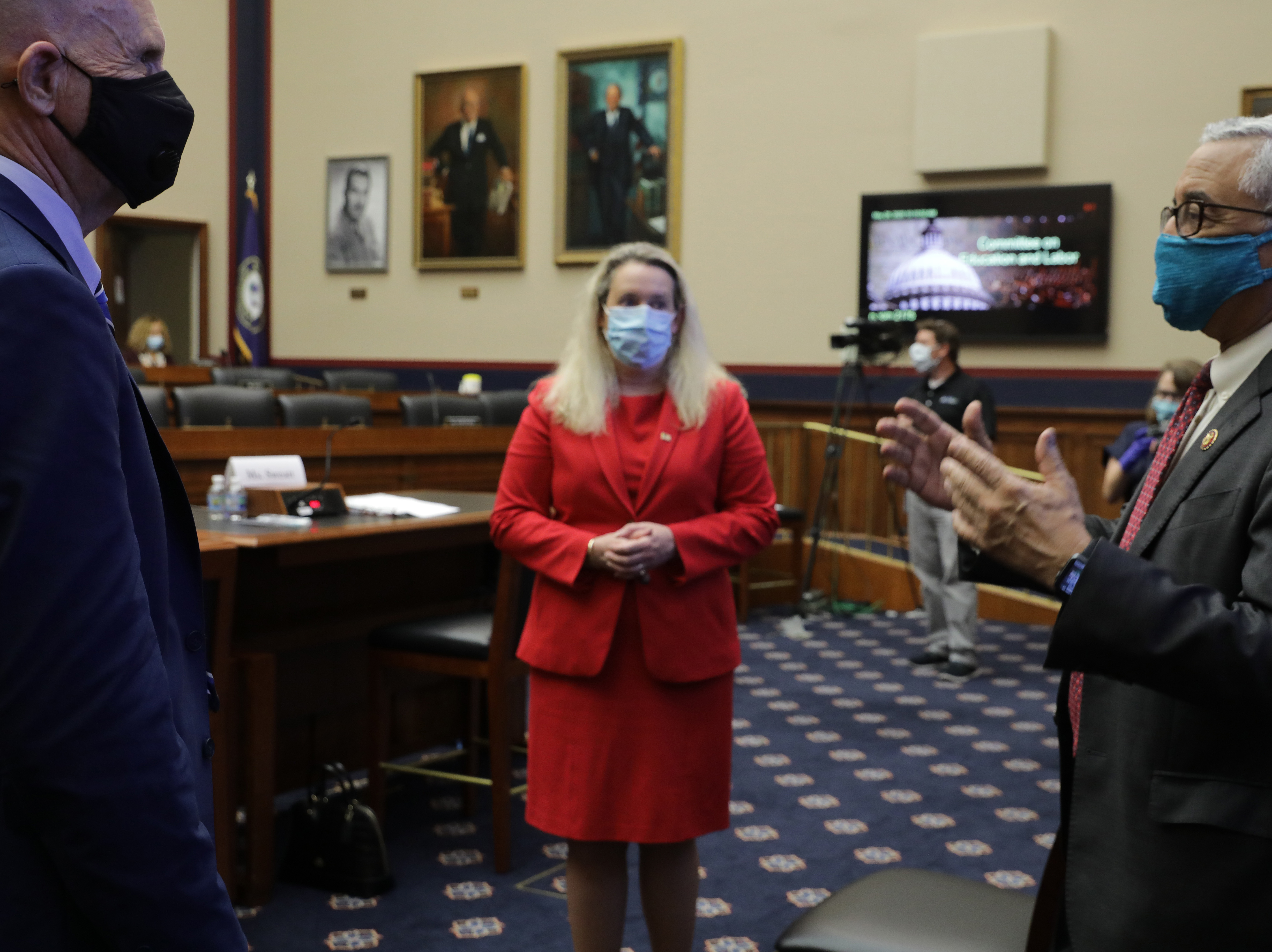 caption: Occupational Safety and Health Administration Principal Deputy Assistant Secretary Loren Sweatt (C) and National Institute for Occupational Safety and Health Director John Howard (L) talk with House Education and Labor Committee Chairman Bobby Scott (D-VA) before a hearing about the federal government's role in protecting workers during the novel coronavirus pandemic on Capitol Hill on Thursday.