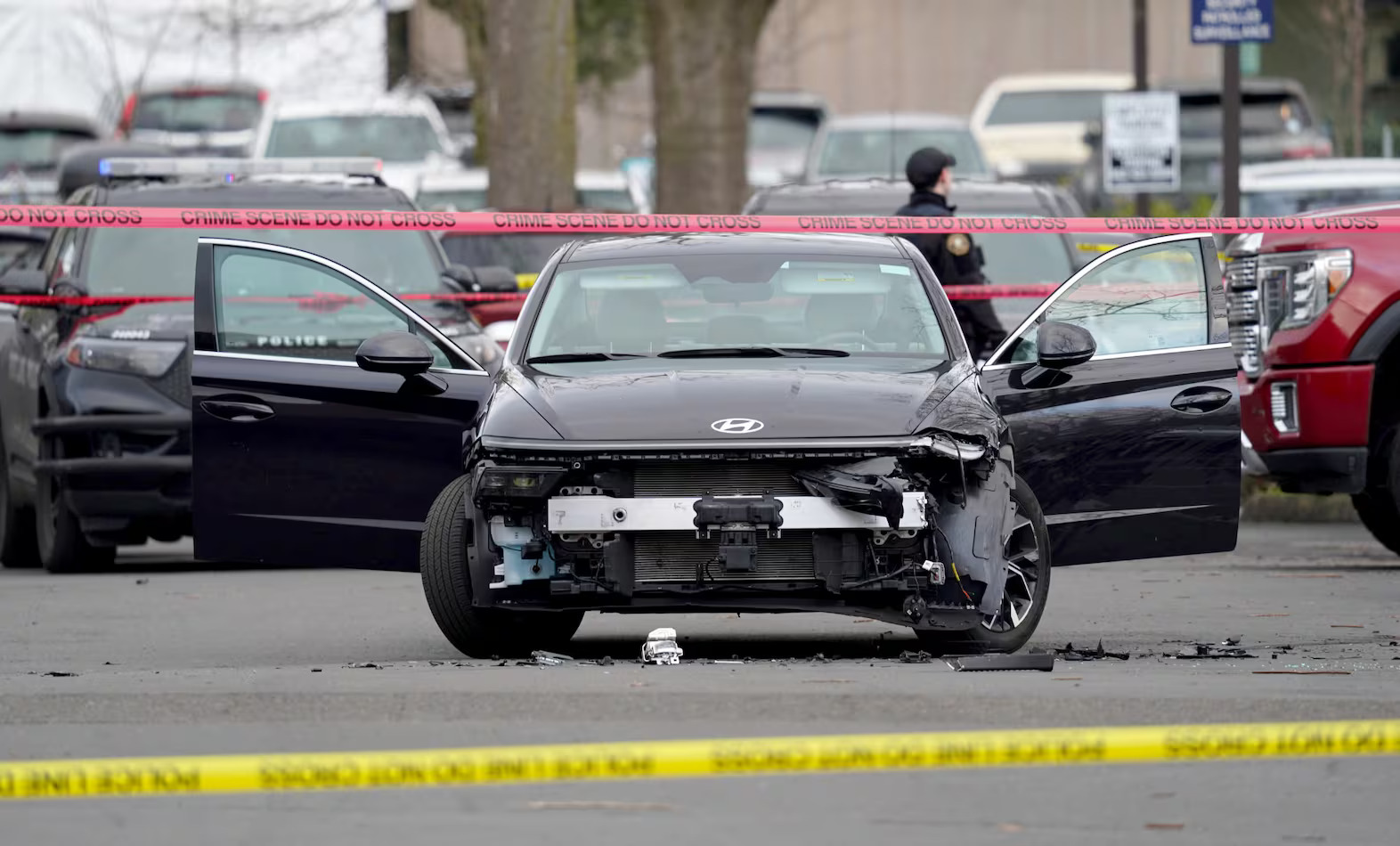 caption: A vehicle is taped off near the 10000 block of Main Street, where two people were shot and wounded Thursday, Jan. 8, 2026, by a U.S. Customs and Border Protection agent in East Portland, according to the Portland Police Bureau and the FBI.