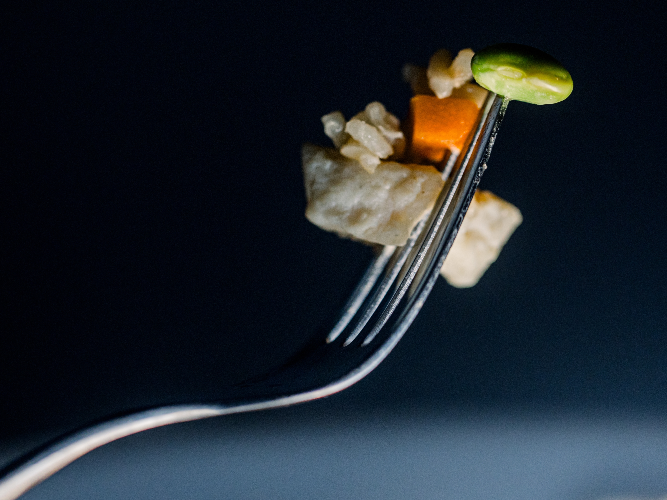 caption: A bite from a Healthy Choice Chicken Fried Rice frozen meal, which includes chicken, rice, carrots and edamame in a sesame sauce. Healthy Choice, a Conagra brand, has a line of frozen meals labeled "On Track," geared toward GLP-1 users.