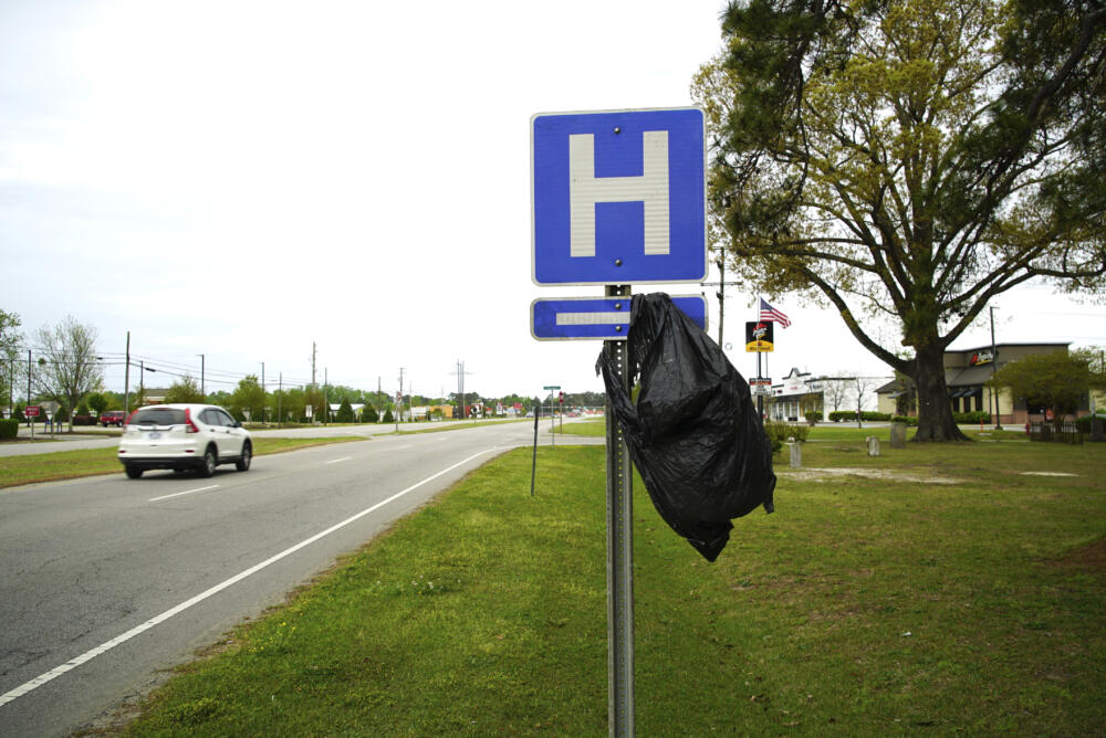 caption: A garbage bag hangs from a hospital sign along U.S. 17 in Williamston, N.C., on Thursday, April 11, 2024. (Allen G. Breed/AP)