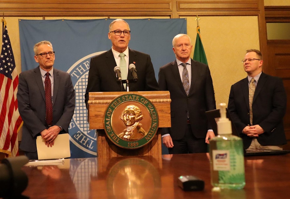 caption: Washington Gov. Jay Inslee is flanked, from left, by state Secretary of Health John Wiesman, Emergency Management Director Robert Ezelle and Superintendent of Public Instruction Chris Reykdal during a coronavirus briefing Monday in Olympia.