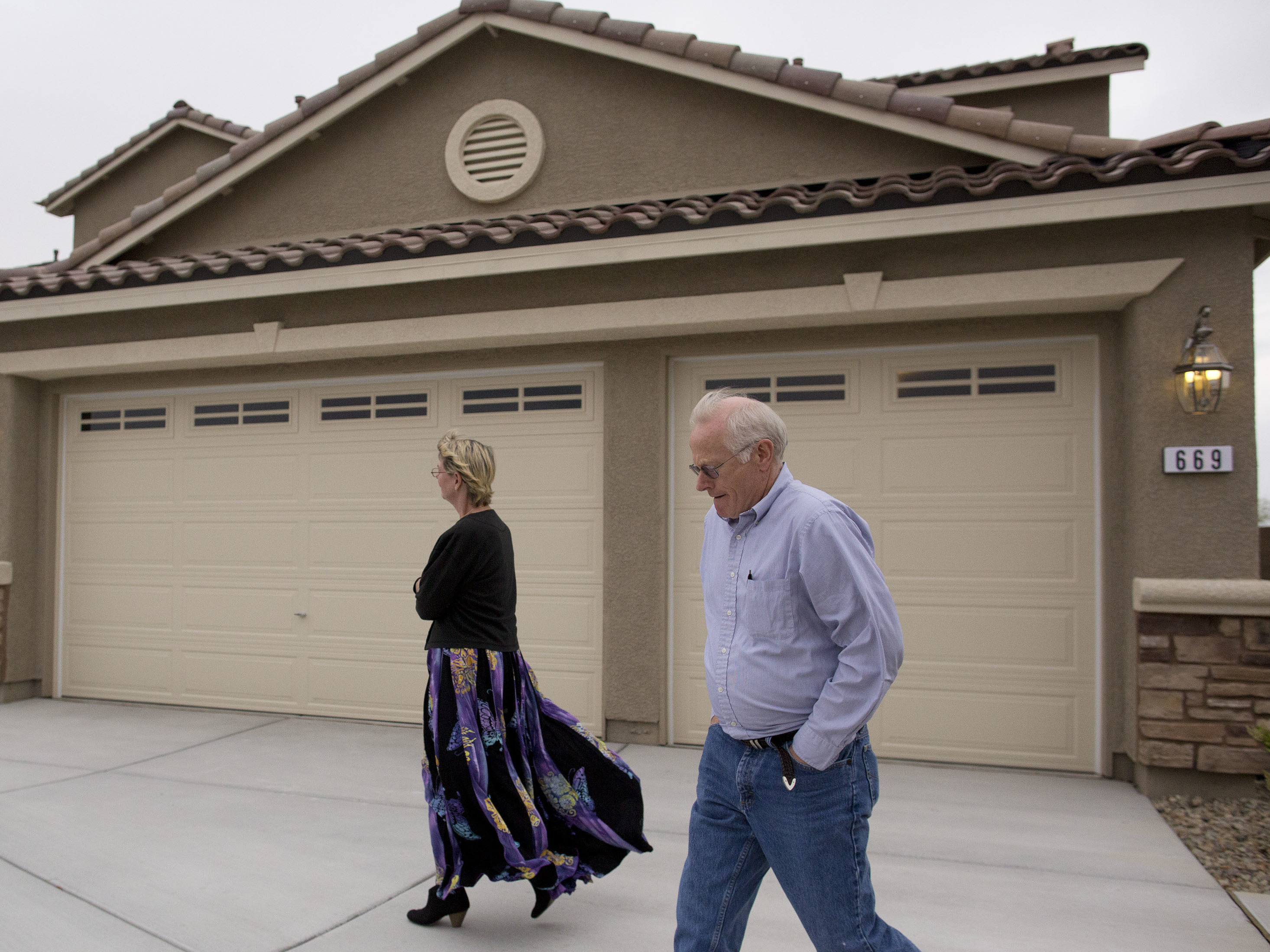 caption: In this Friday, April 13, 2012 photo, Kelly, left, and Bill Noorish walk around a model a Lennar Next-Gen multigenerational home, in Las Vegas.