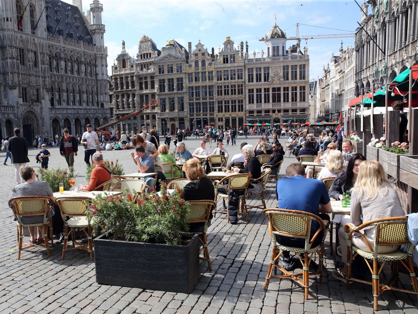 caption: People enjoy the May sunshine from the cafe terraces of Brussels' Grand Place. On Friday, European Union added the United States to the list of countries whose citizens and residents should be allowed to travel freely within the bloc.