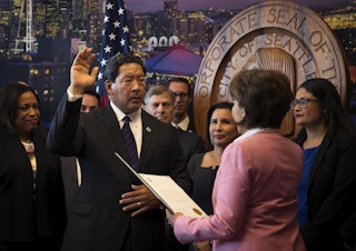 caption: Seattle City Council President Bruce Harrell is sworn into office by city clerk Monica Simmons, right, becoming the mayor of Seattle, on Wednesday, September 13, 2017, at City Hall.