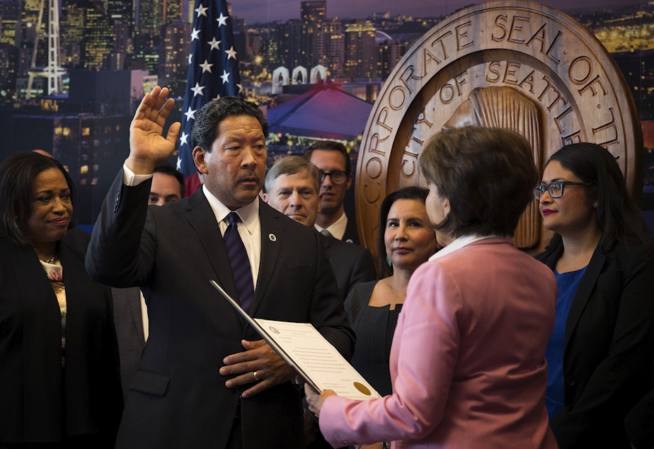 caption: Seattle City Council President Bruce Harrell is sworn into office by city clerk Monica Simmons, right, becoming the mayor of Seattle, on Wednesday, September 13, 2017, at City Hall.
