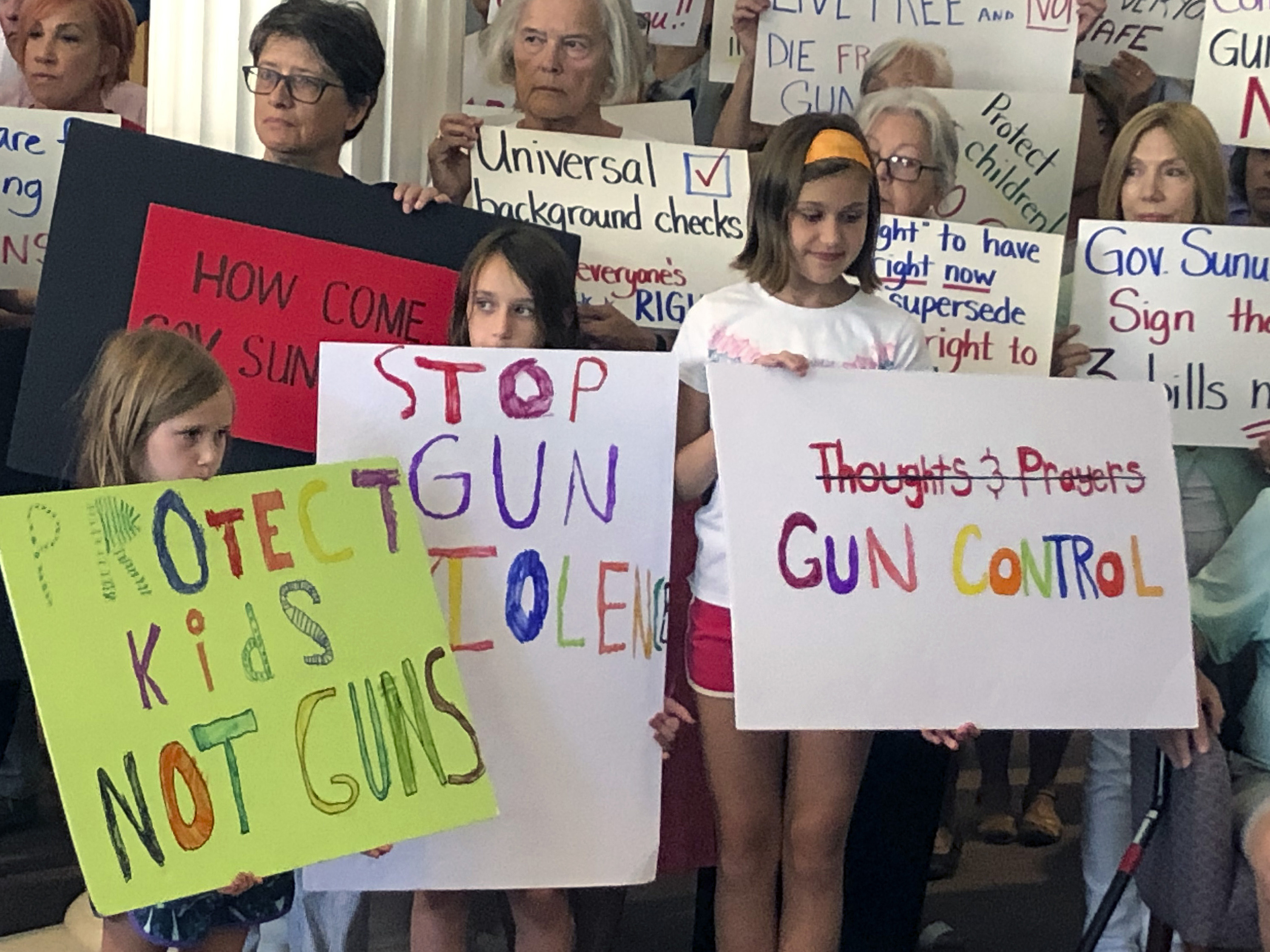 caption: Supporters of gun control measures gather at the Legislative Office Building in Concord, N.H., in August, to urge Republican Gov. Chris Sununu to act after mass shootings in Texas and Ohio.
