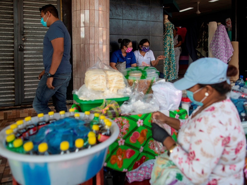 caption: People wear face masks as a preventive measure against the spread of the new coronavirus, COVID-19 at a market in Managua, on April 16, 2020, a day after Nicaraguan President Daniel Ortega spoke of the coronavirus pandemic and announced there would be no quarantine or cessation of economic activity.