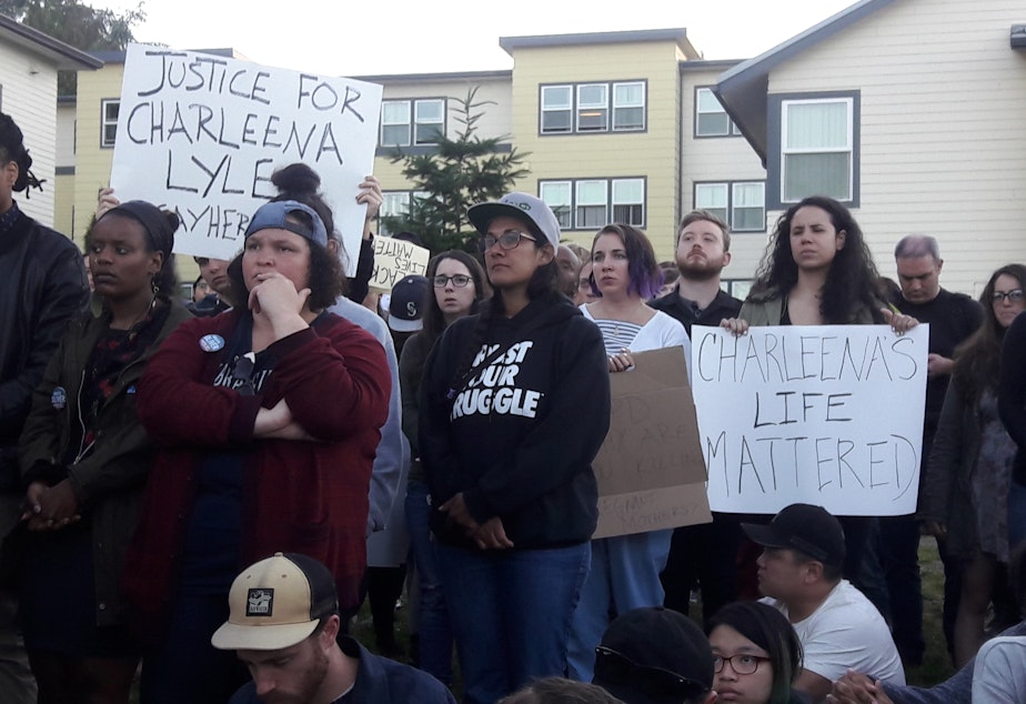 caption: Dozens gathered for a vigil held for a woman shot by Seattle Police