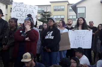 caption: Dozens gathered for a vigil held for a woman shot by Seattle Police