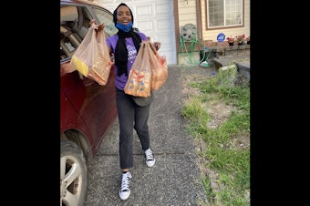 caption: Marian Mohamed: "Here I am carrying multiple bags of groceries back home from Fred Meyers in Kent, Washington, before heading inside my house to put them away."