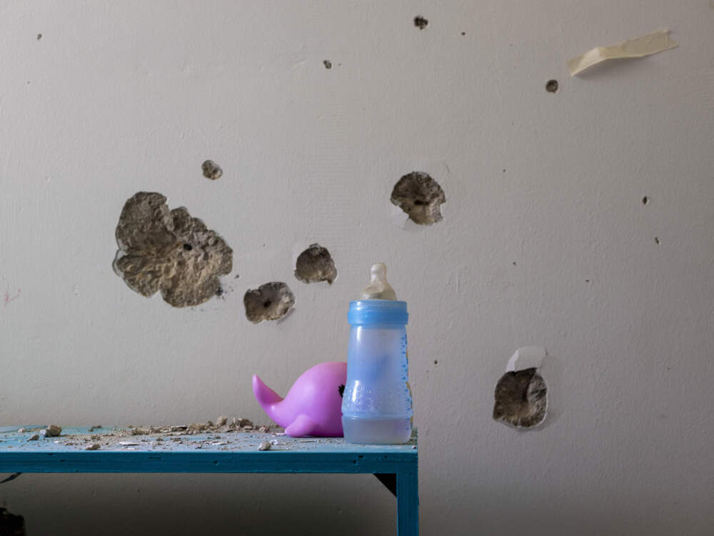 caption: Bullet holes cover the bedroom wall of hostage Ariel Bibas, 4, in Kibbutz Nir Oz, Israel, on Friday, June 21, 2024. Ariel was kidnapped on Oct. 7, with his infant brother, Kfir, now 1, his mother, Shiri, and his father, Yarden. (Oded Balilty/AP)