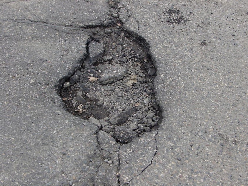 caption: A Seattle pothole that resurfaces every few months.