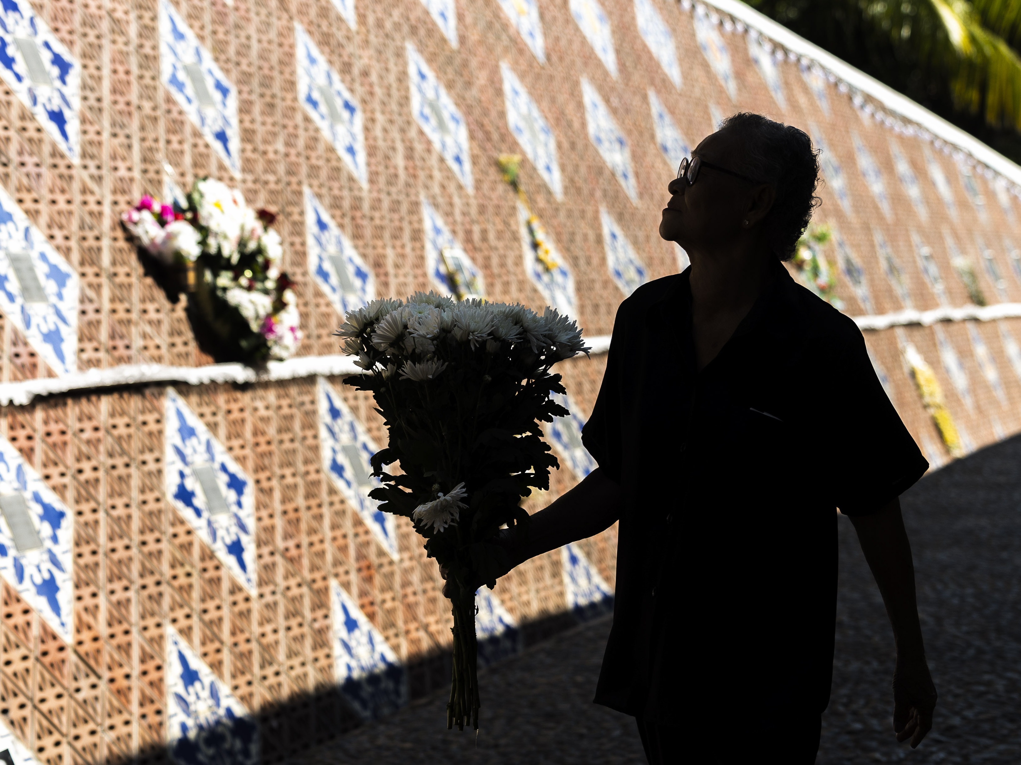 caption: A relative of a victim of a 2004 Indian Ocean tsunami participates in its 20th anniversary at Tsunami Memorial Park at Ban Nam Khem, Takuapa district of Phang Nga province, southern Thailand, Thursday, Dec. 26, 2024.