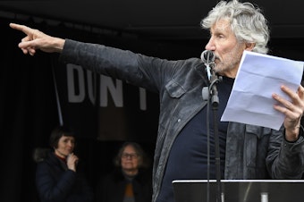 caption: British musician Roger Waters speaks at a rally in Parliament Square, London, as part of the demonstration against the extradition of Julian Assange on Saturday.
