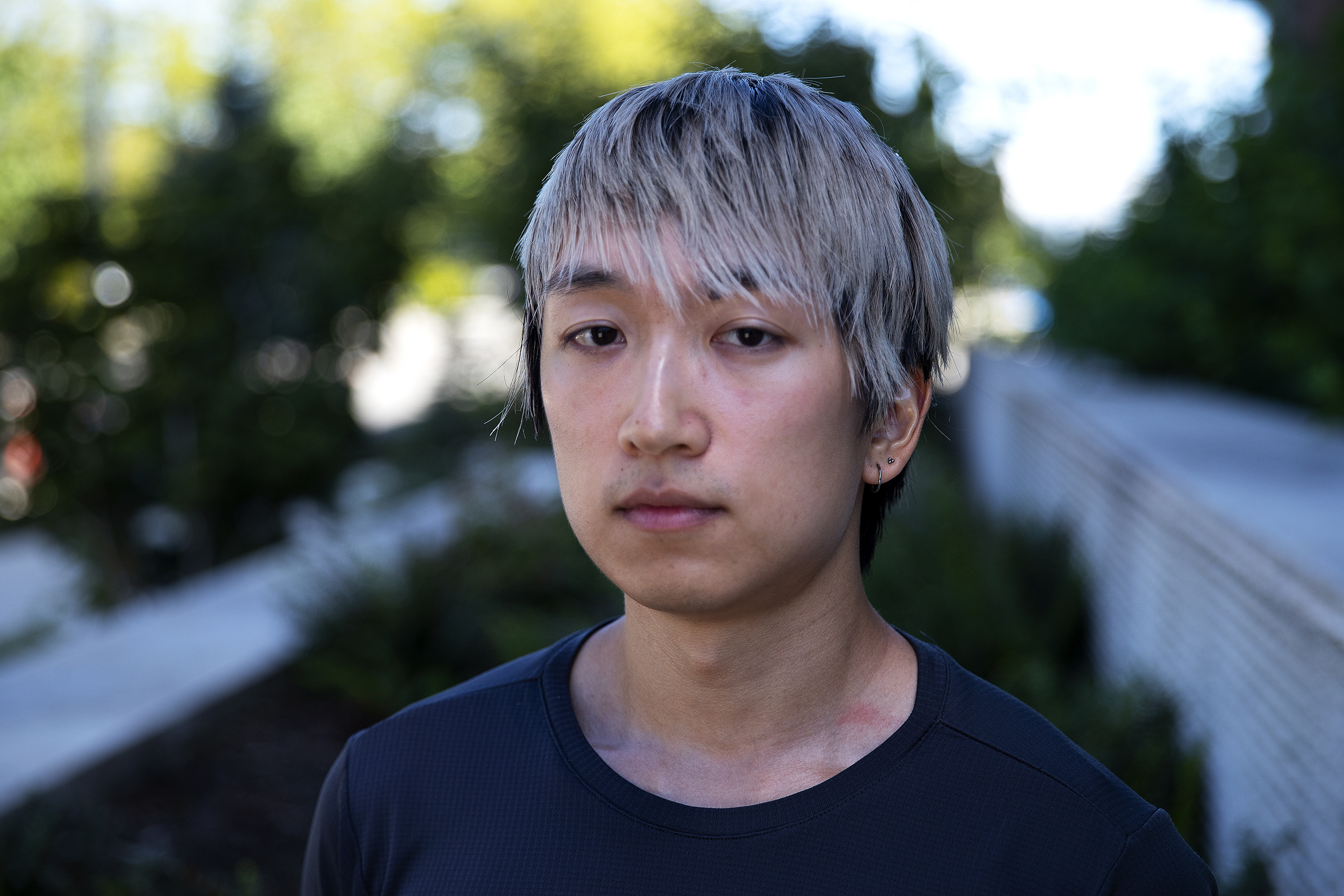 caption: Microsoft software engineer Julius Shan, 28, is portrayed on Wednesday, August 20, 2025, near the Microsoft East Campus Plaza in Redmond. Shan is under a suspension from Microsoft for the second time. 