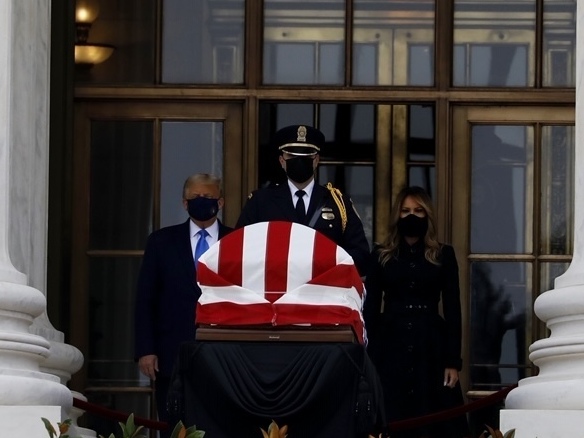 caption: President Trump and first lady Melania Trump pay their respects to the late Justice Ruth Bader Ginsburg as she lies in repose at the U.S. Supreme Court.