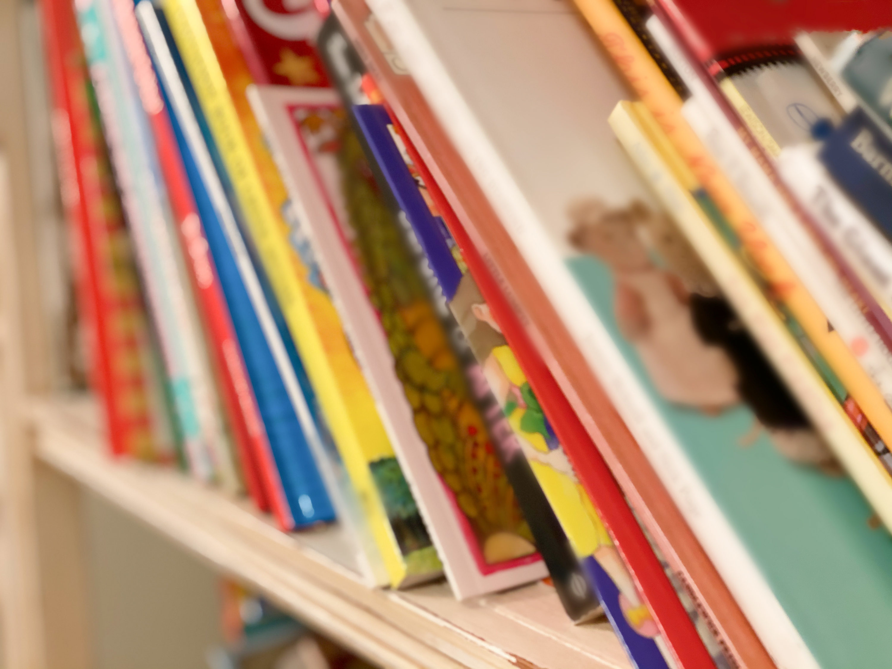caption: A bookshelf packed with children's books. (Catherine McQueen/Getty Images)