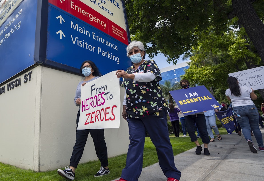 caption: Health care workers protest hospital understaffing and insufficient personal protective equipment last week outside Providence St. Joseph Medical Center in Burbank, Calif.