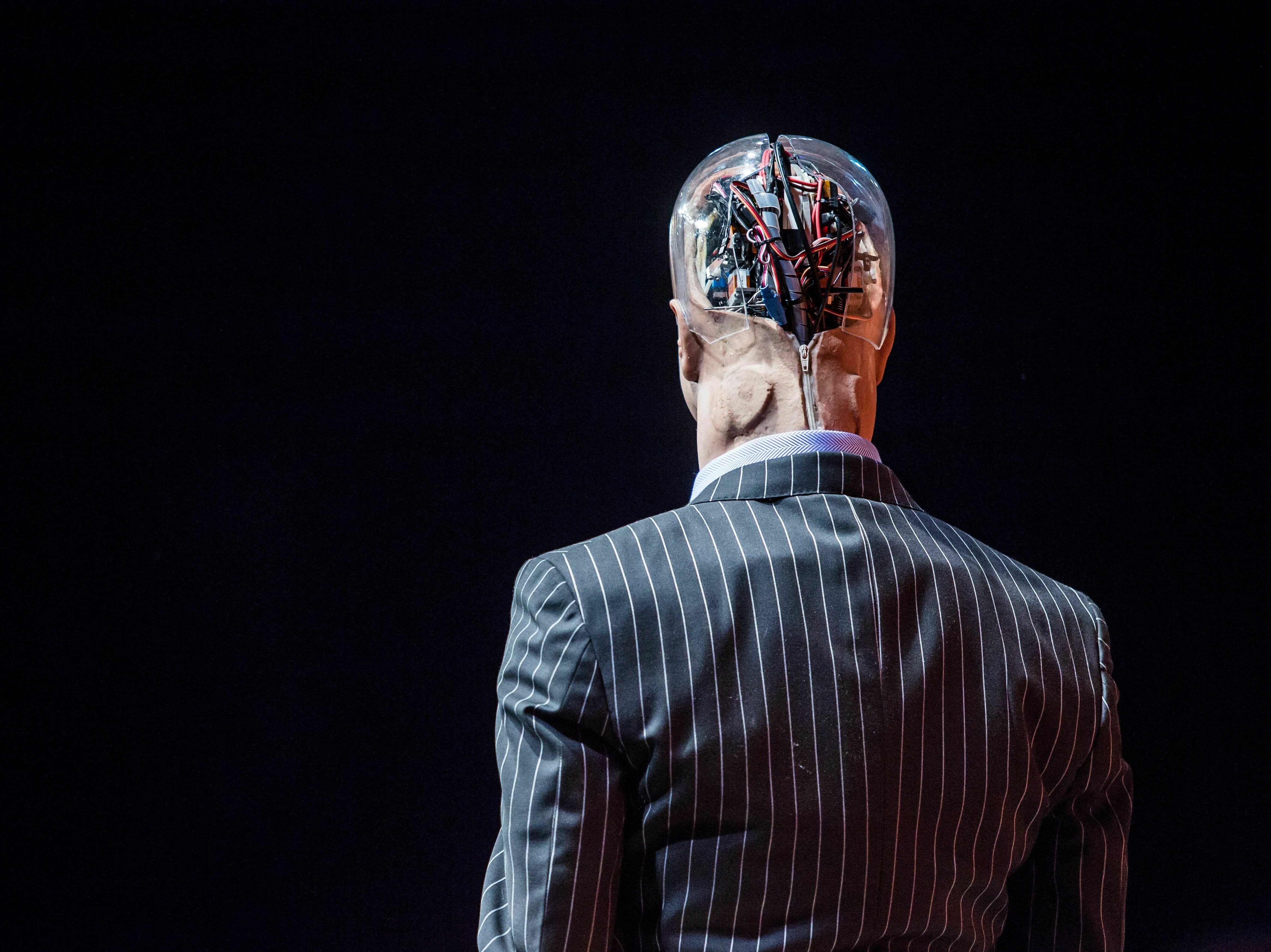 caption: Robot business man go brrrr.