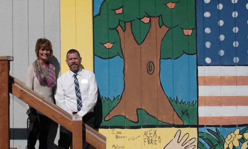 caption: Puyallup School District principal Michelle Cruckshank and spokesperson Brian Fox stand outside a portable classroom – one of 232 the district now has at its schools.