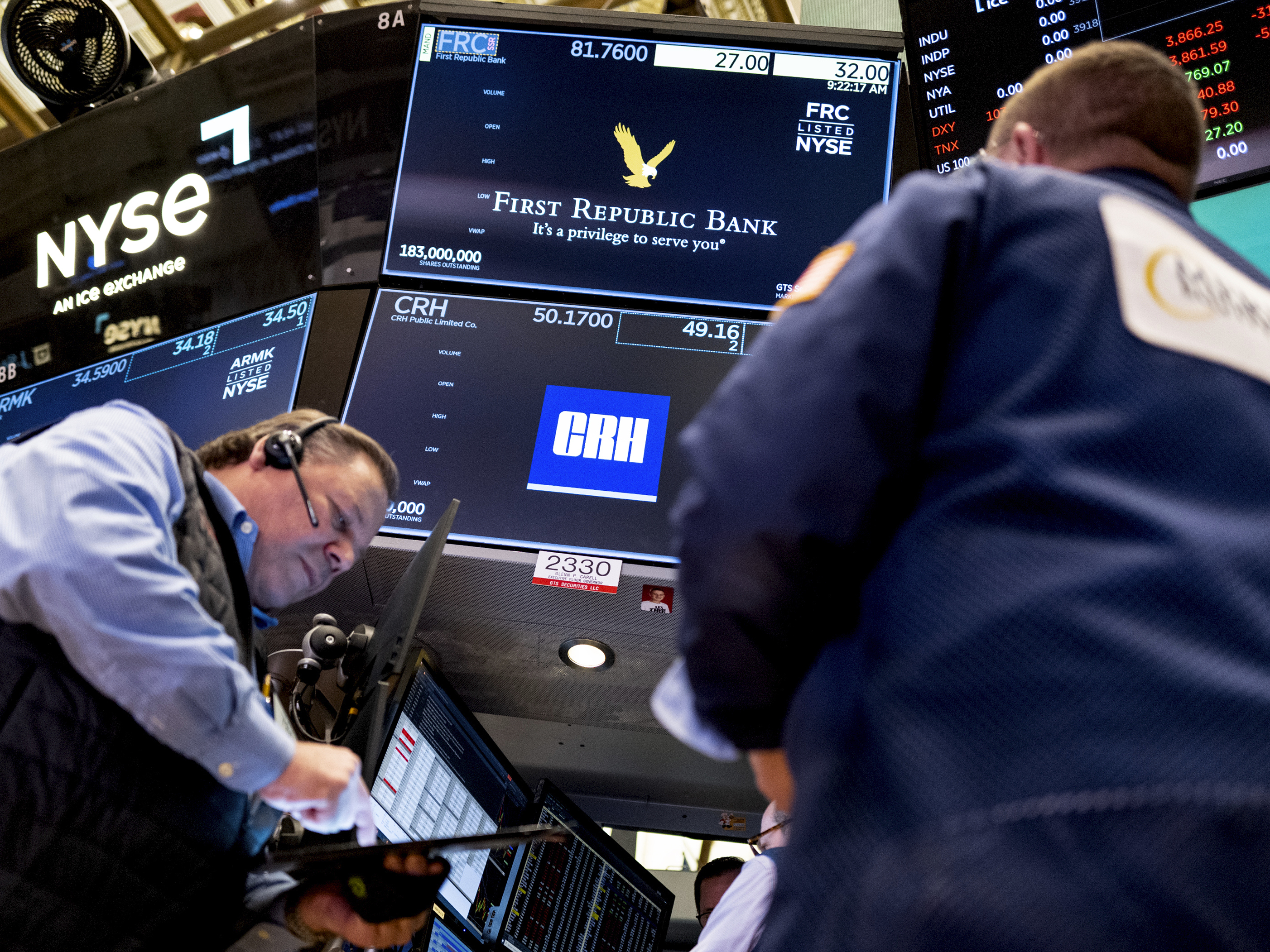 caption: Traders work on the floor at the New York Stock Exchange in New York on March 13.