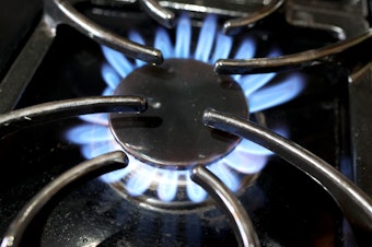 caption: Flames burn on a natural gas-burning stove on January 12, 2023 in Chicago, Illinois. New research from Stanford University show gas stoves emit benzene, which is linked to cancer.