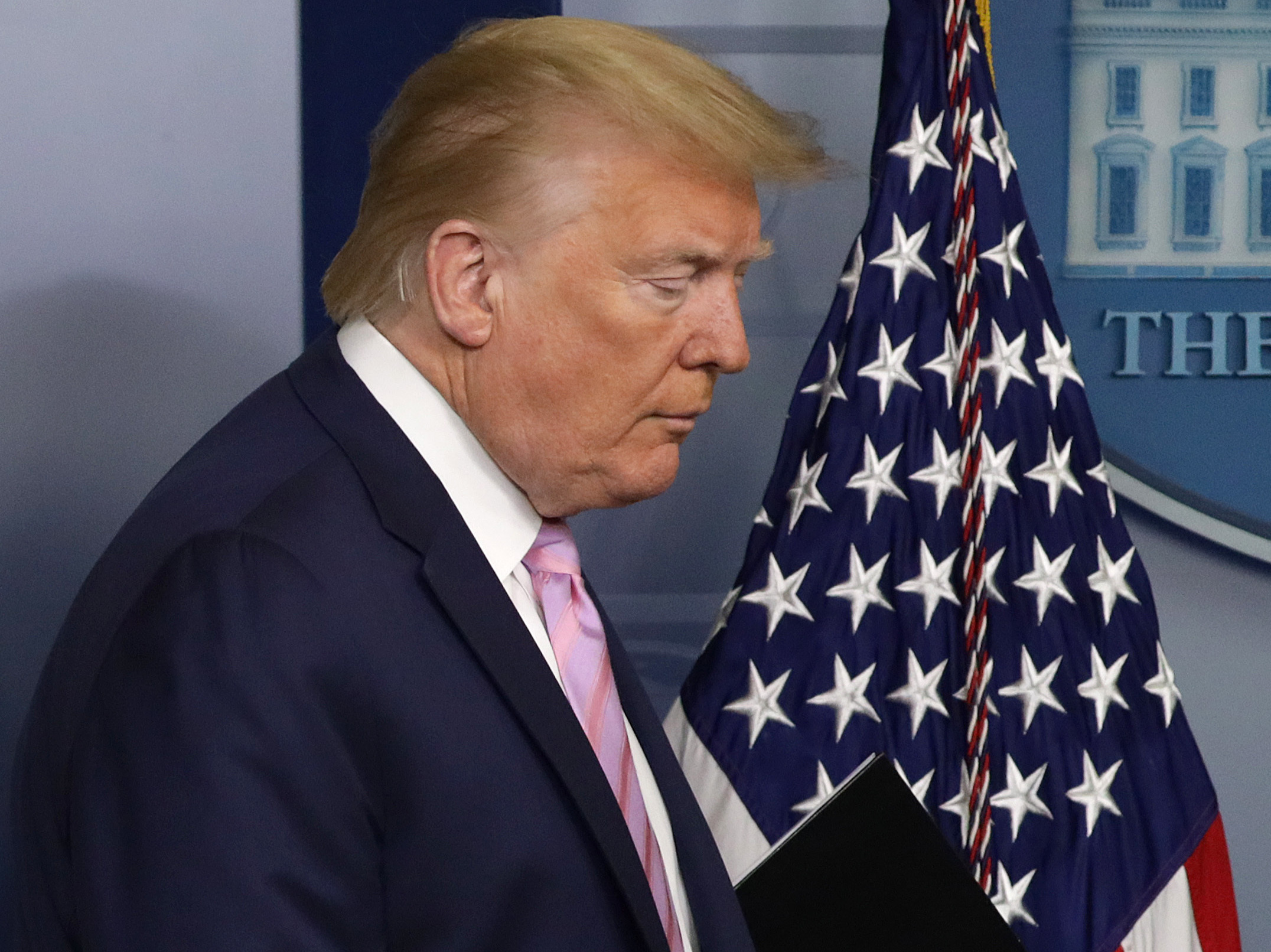 caption: When it comes to the president's grasp of the coronavirus pandemic, more Americans now disapprove 48.9% — than approve — 46.8% — of President Trump's job performance.