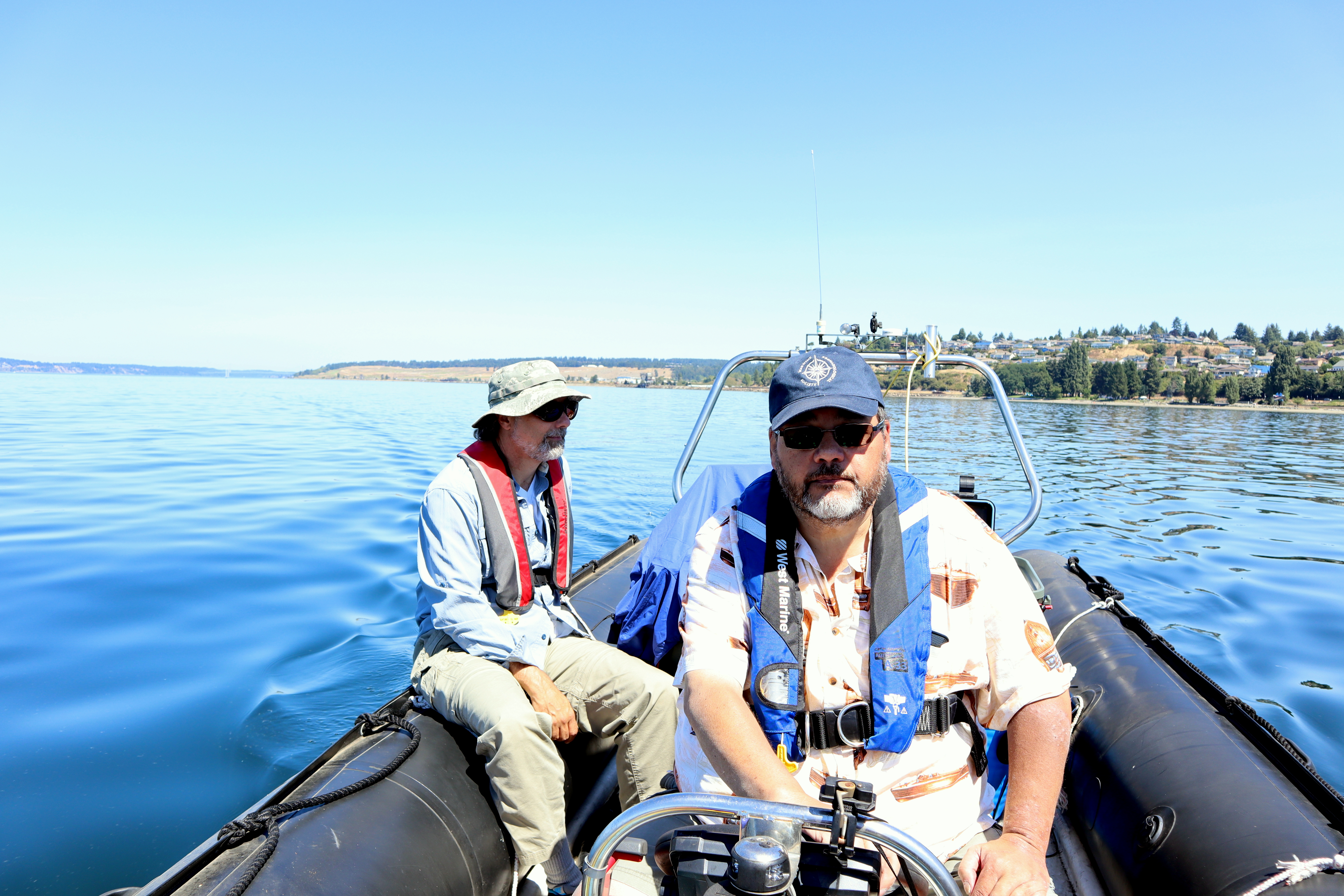 caption: Shipwreck hunters Jeff Groth, right, and Scott Williams methodically towed a magnetometer back and forth over a search grid -- "mowing the lawn," as they called it.
