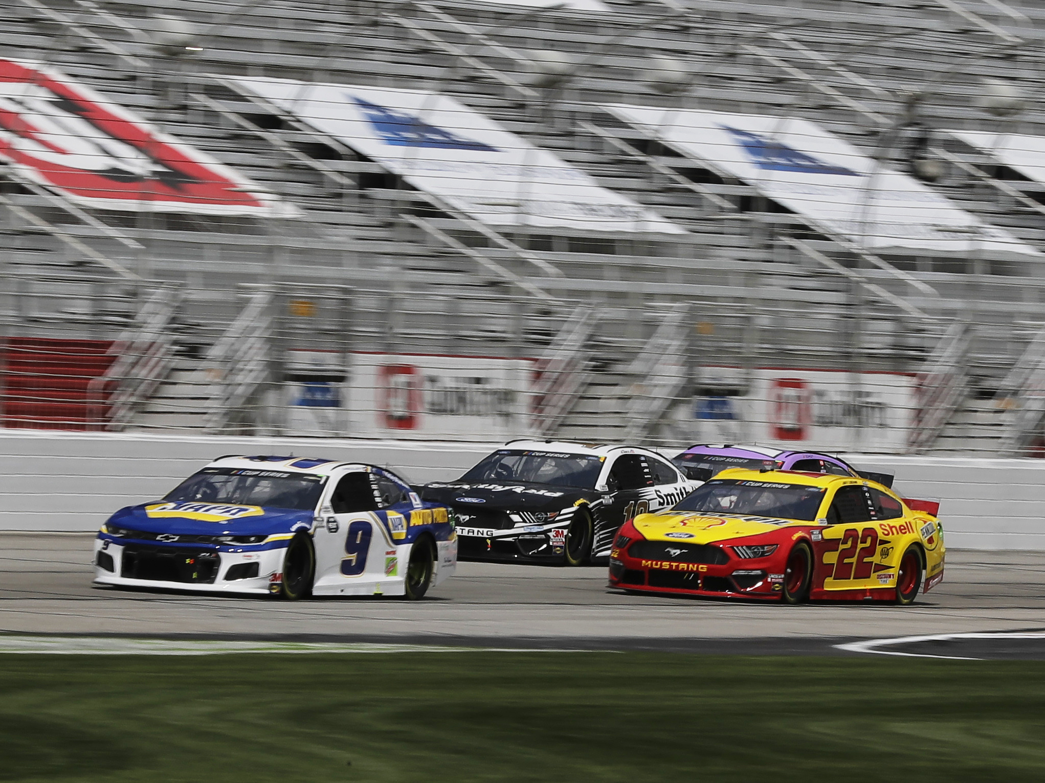 caption: Chase Elliott (9), Aric Almirola (10) and Joey Logano (22) drive during a NASCAR Cup Series auto race at Atlanta Motor Speedway on Sunday in Hampton, Ga. On Wednesday, NASCAR announced a ban of the Confederate battle flag at all of its events and properties.