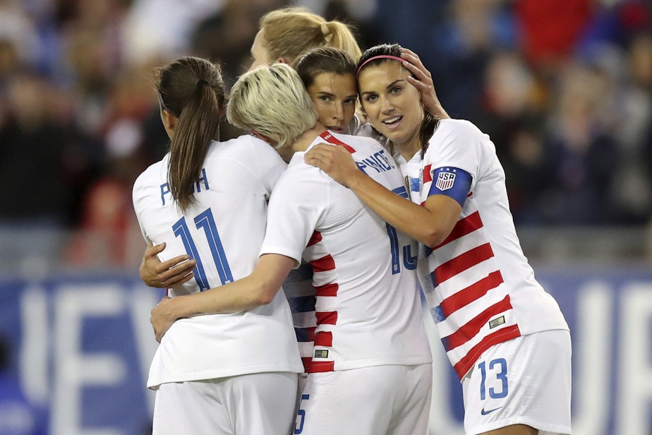 caption: United States' Tobin Heath, second from right, is congratulated on her goal by Mallory Pugh (11), Megan Rapinoe and Alex Morgan (13) during the first half of a SheBelieves Cup soccer match against Brazil in Tampa, Fla., March 5, 2019. (Mike Carlson, File/AP)