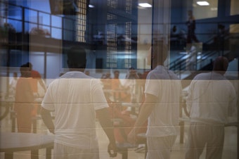 caption: Male detainees are shown in one of the housing units on Tuesday, September 10, 2019, at the Northwest Detention Center, renamed the Northwest ICE Processing Center, in Tacoma.