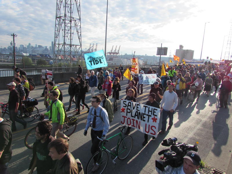 caption: Protesters marching toward the Port of Seattle’s Terminal 5.