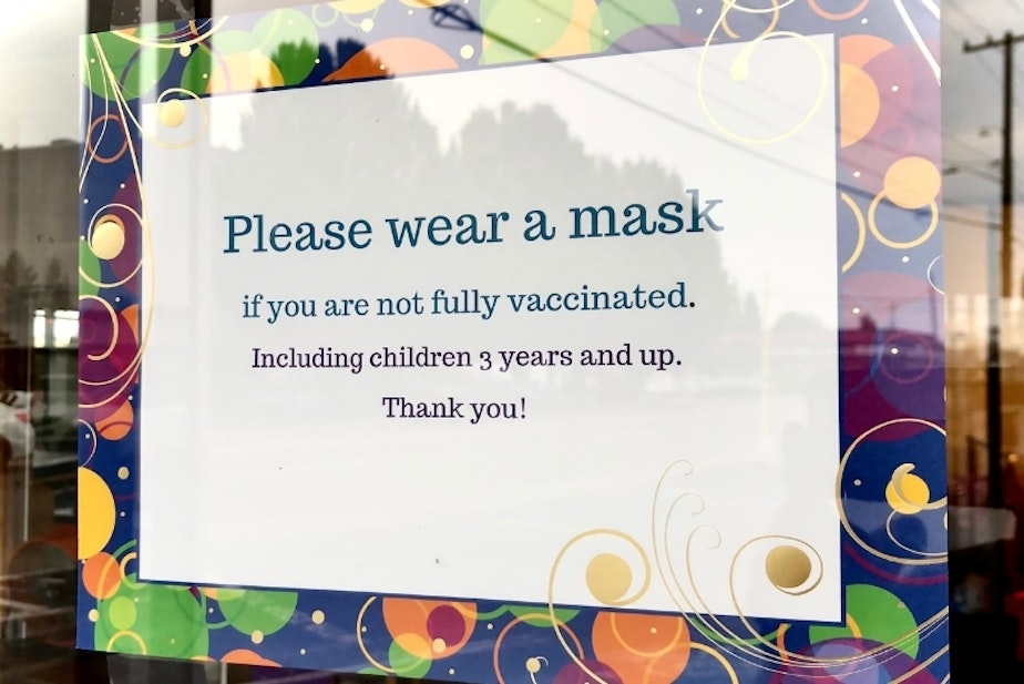 caption: A sign at a children's business in Burien in late July 2021 requests that patrons wear masks. 