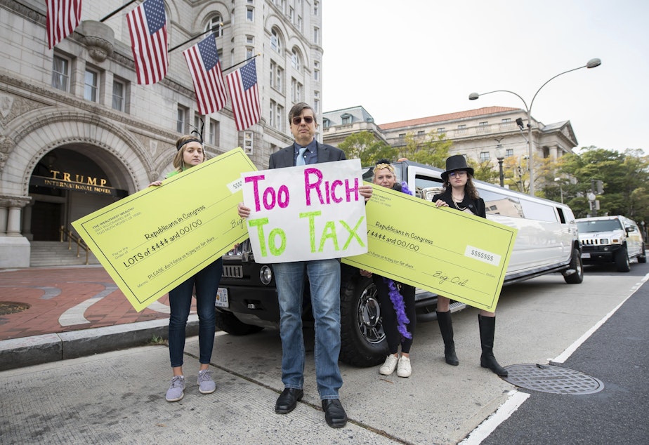 caption: Satirical "corporations and the wealthy" protest outside the Trump Hotel, in support of higher taxes on the rich in the Build Back Better plan on Thursday, Nov. 4, 2021, in Washington. 
