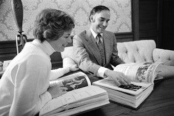 caption: Outgoing Washington Gov. Dan Evans and his wife Nancy eye one of 24 scrapbooks put together during Evans' 12 years in office, in Olympia, Wash., Dec. 15, 1976. The fascinating collection of memorabilia includes invitations from the queen of England, warm notes from Richard Nixon, some previously undisclosed political information and irate letters, like one calling for his impeachment. 