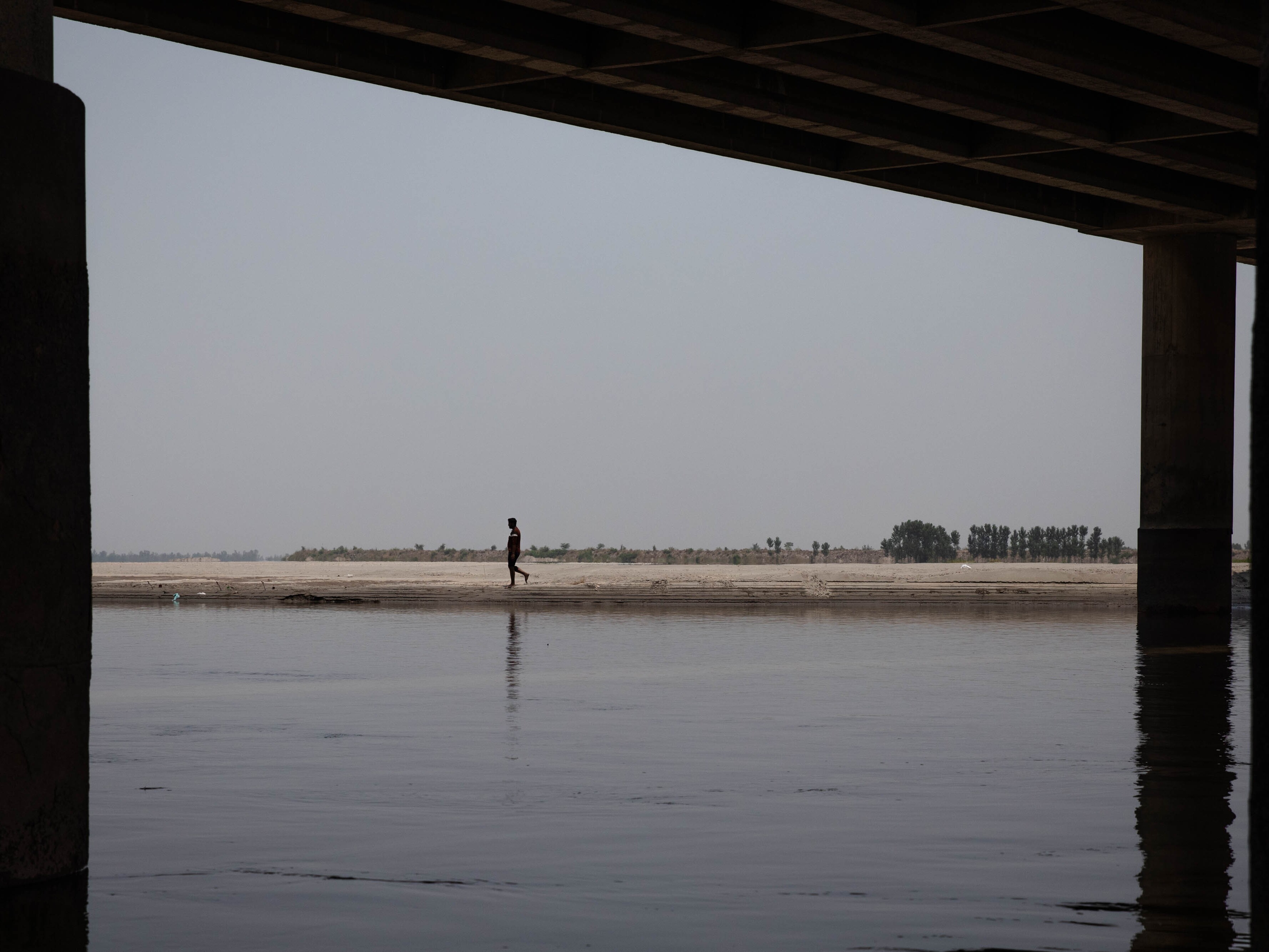 caption: The Chenab, one of the three rivers allocated to Pakistan under the Indus Waters Treaty, seen from the riverbank in early June in Punjab province, Pakistan.