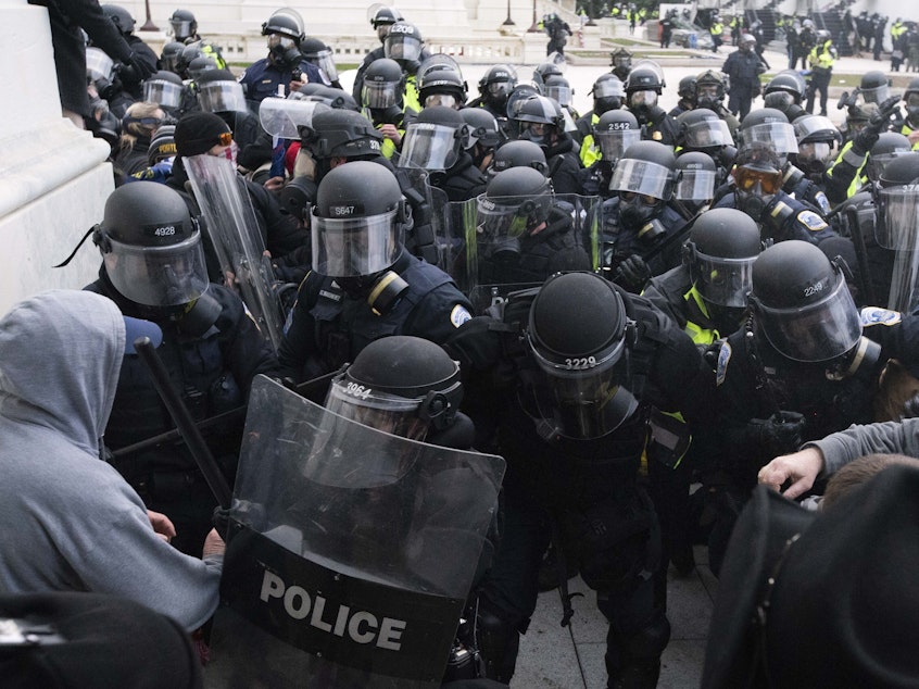 caption: U.S. Capitol Police push back rioters trying to enter the U.S. Capitol in Washington on Jan. 6.