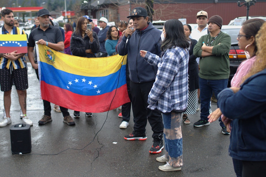 caption: Frey is an organizer with the Venezuelan asylum hopefuls. He says they've been so busy trying to find safety. He's speaking here alongside an interpreter in front of the Kent Quality Inn Jan. 29th. 