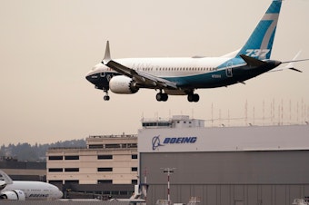 caption: A Boeing 737 MAX jet, piloted by Federal Aviation Administration chief Stephen Dickson, prepares to land at Boeing Field following a test flight late September in Seattle.