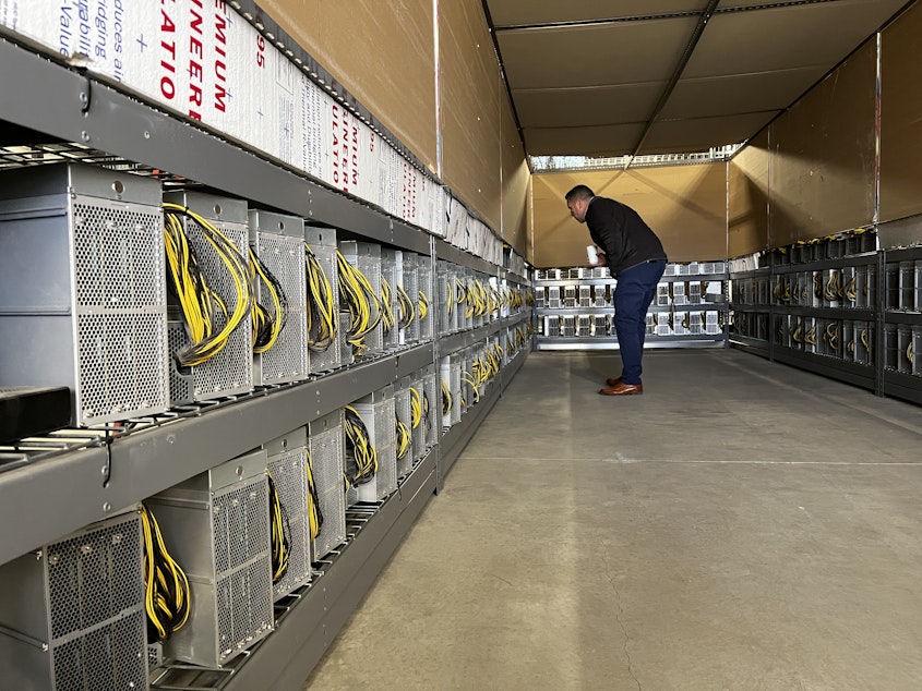caption: Malachi Salcido, of Salcido Enterprises, looks over his cryptocurrency servers at the Pangborn Data Center in Wenatchee.