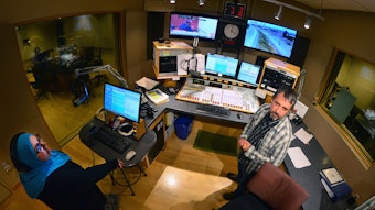caption: 'The Record' producer Amina Al-Sadi and announcer Bernard Ouellette in the KUOW control room.