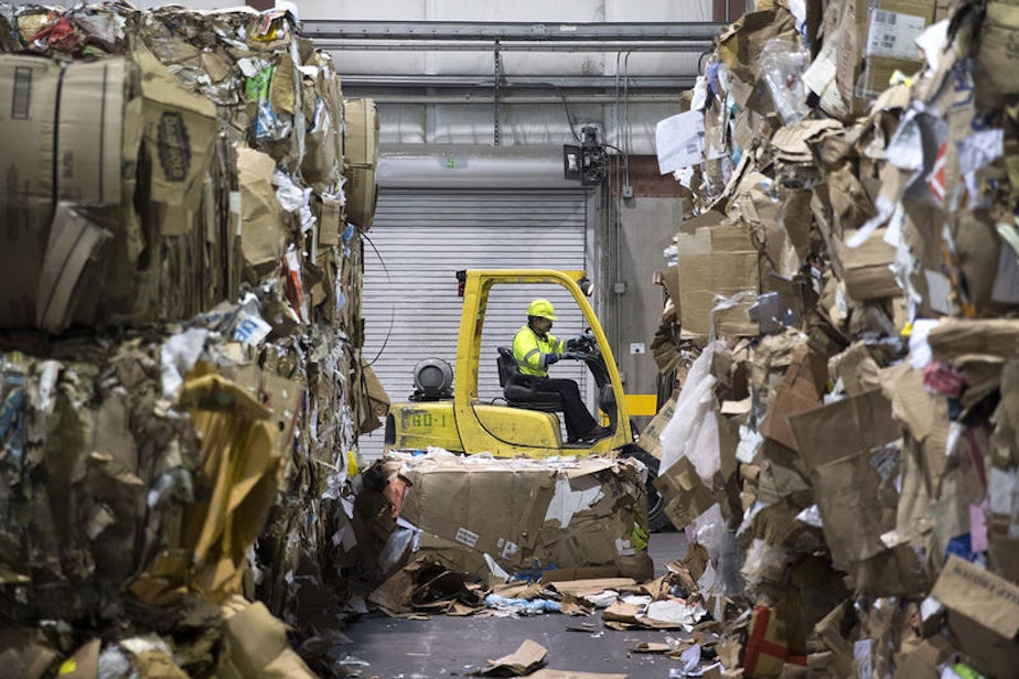 caption: Bales of cardboard, left, and mixed paper, right, are shown on the loading dock at the Recology CleanScapes Materials Recovery Facility on Tuesday, October 31, 2017, on S. Idaho St., in Seattle.
