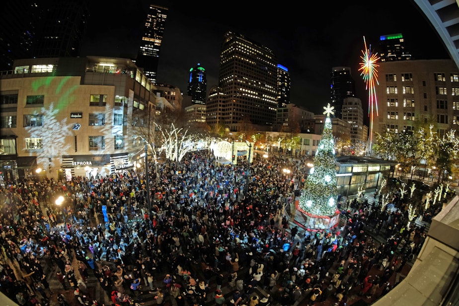 caption: Westlake Park during the tree lighting ceremony in late November. In the background, the historic star mounted on the former Macy's building was recently restored by Amazon