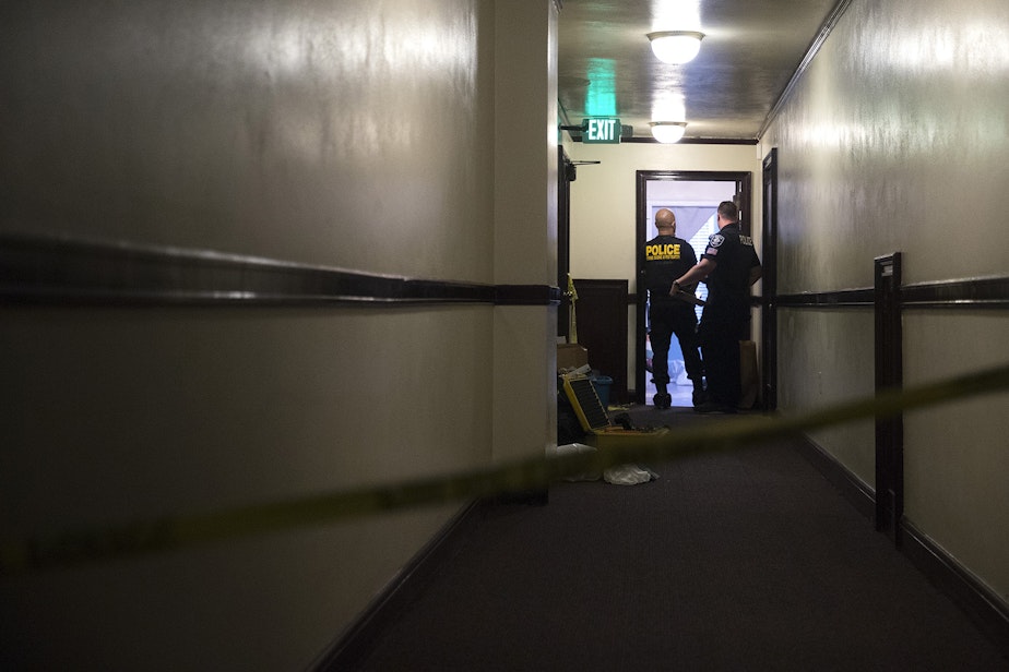 caption: Police investigate the scene where two women were found dead on Monday, September 4, 2018, at the Malloy Apartments near the intersection of Northeast 43rd Street and 15th Avenue Northeast in Seattle.