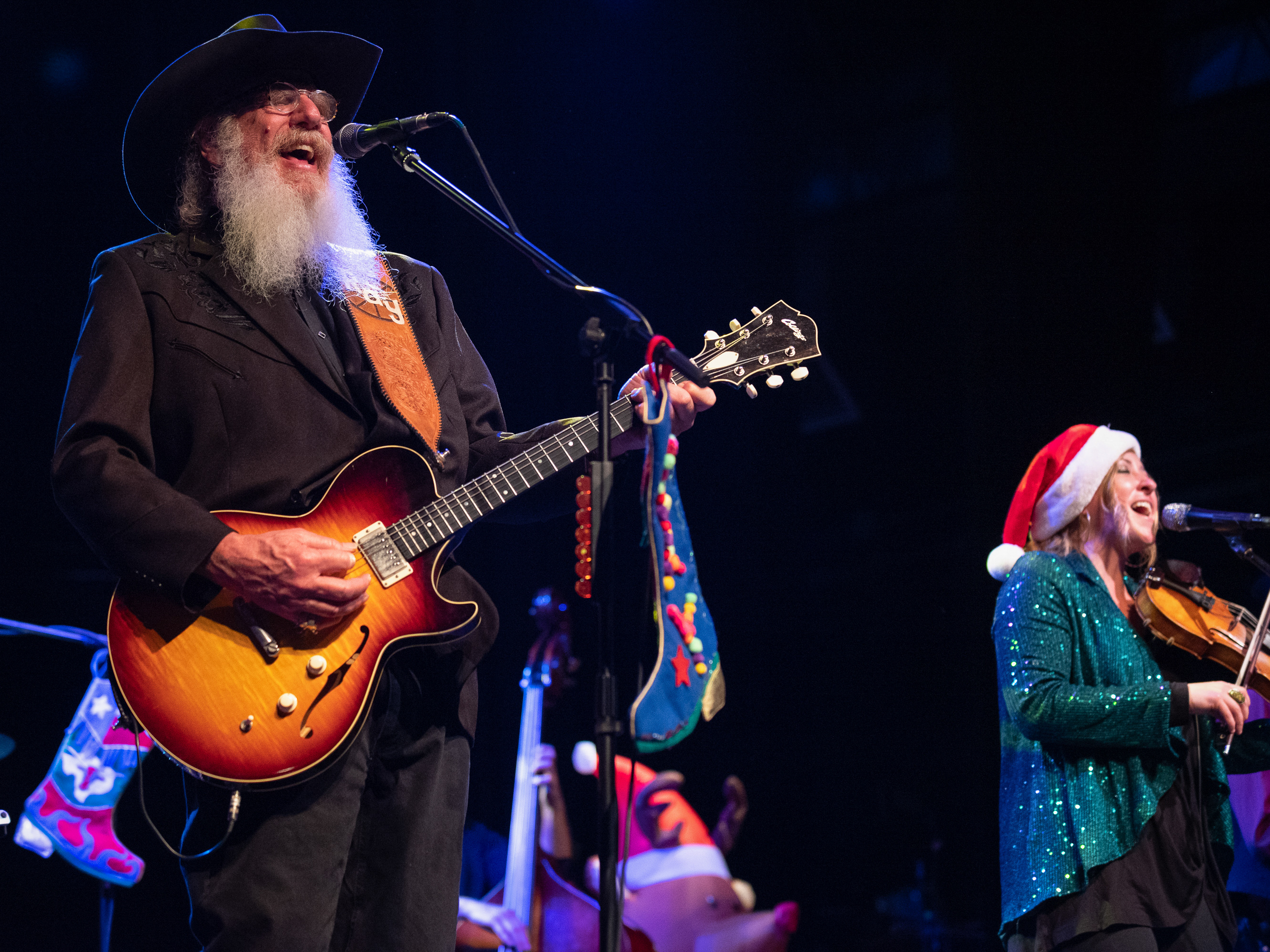 caption: Ray Benson, longtime leader of the Western swing group Asleep at the Wheel, in concert at the Palace Theatre in Corsicana, Texas, on Dec. 9, 2022. He says he steers clear of politics on stage because "now it's totally toxic."
