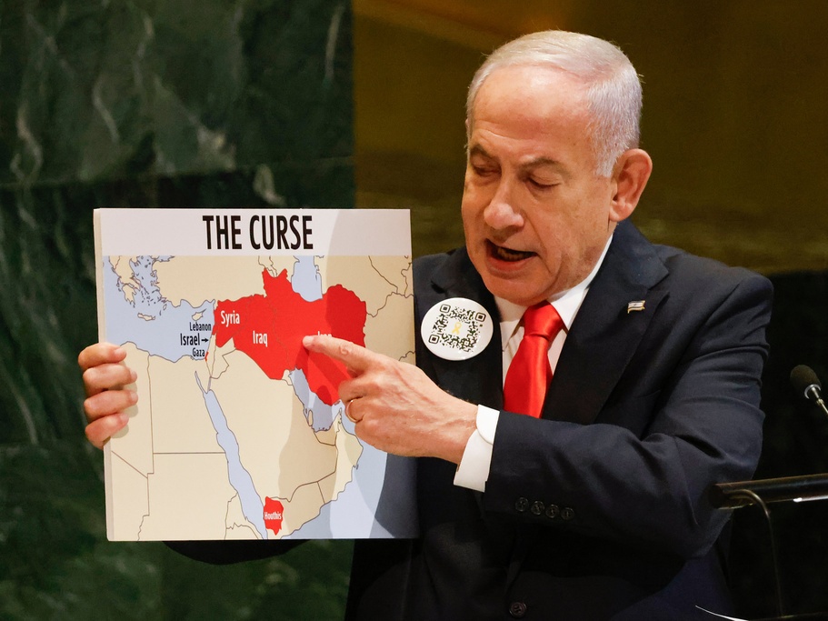 caption: Israeli Prime Minister Benjamin Netanyahu holds up a map Friday while speaking at the 80th session of the United Nations General Assembly, at U.N. headquarters.