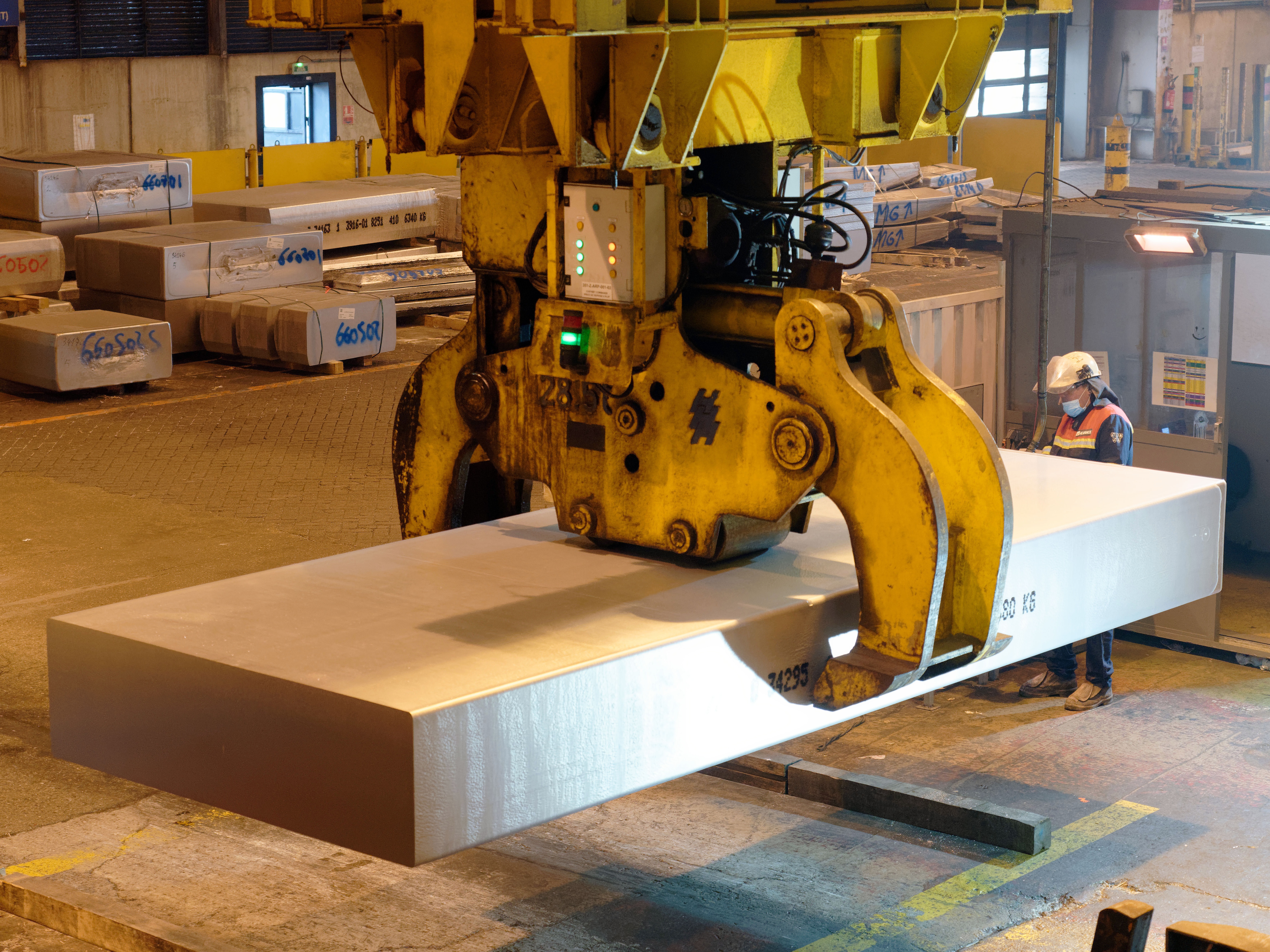 caption: A worker manipulates a block of aluminum in a French smelter in 2022. President Trump has increased tariffs on imported aluminum from 10% to 25%, while also removing exceptions from tariffs on steel. Both metals are crucial raw materials for the automotive sector.