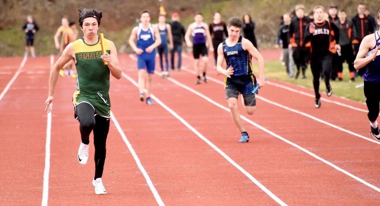 caption: Pendleton High School senior Marcus Aaron Luke, left, was excited and ready for his last year running track. Then coronavirus disrupted everyone's plans.